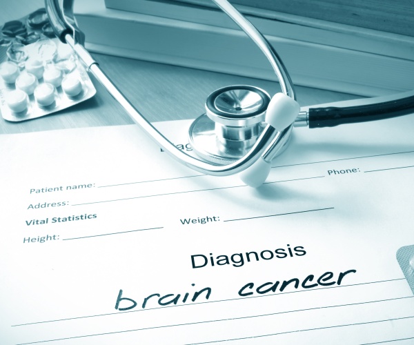 diagnosis pad with 'brain cancer' written in, stethoscope, pills