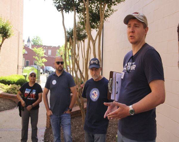 men standing around speaking