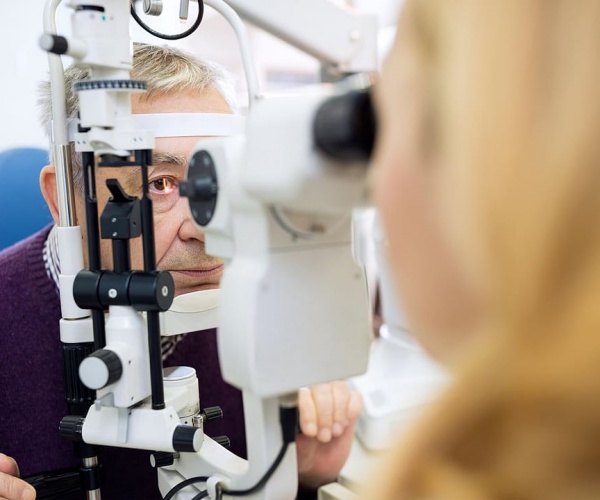 older man undergoing eye tests at doctor's office