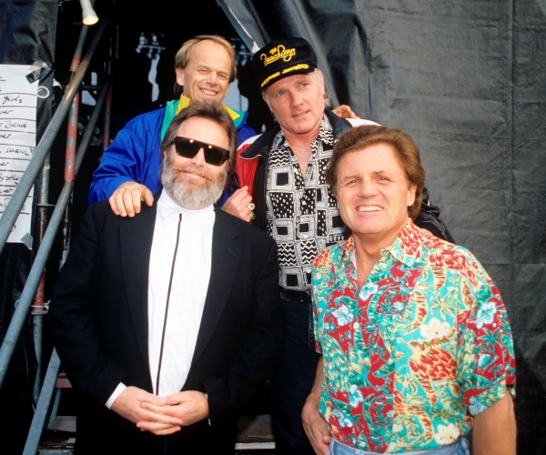 members of the beach boys are shown standing on the steps of a staircase