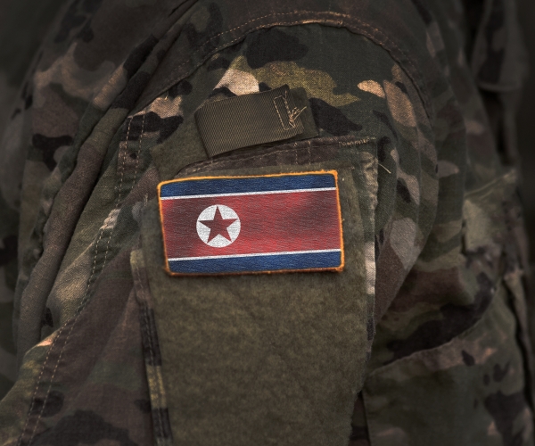 the north korea flag on soldiers arm