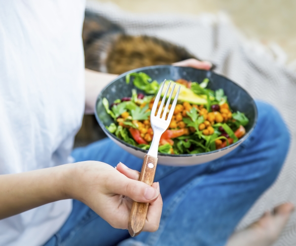 a woman holding a salad bowl