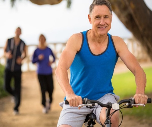 man on bike in foreground, and two bikers behind him