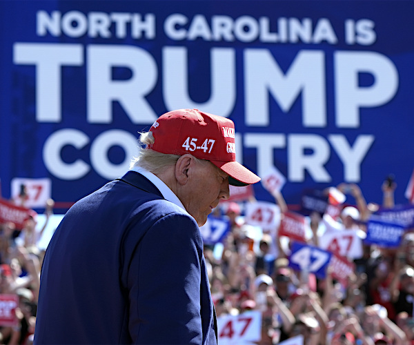 donald trump looks down at a rally