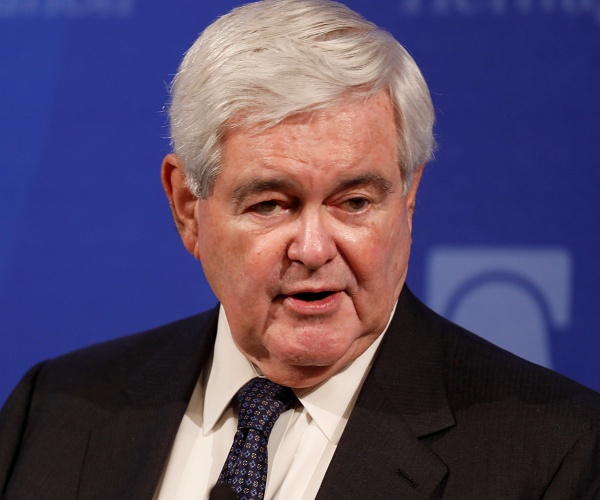 newt gingrich stands onstage