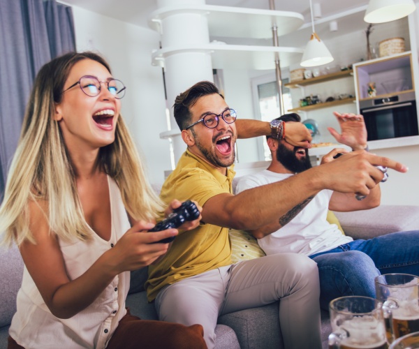 friends playing video games at home 