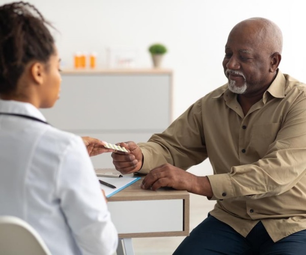 doctor and older man discussing treatment options