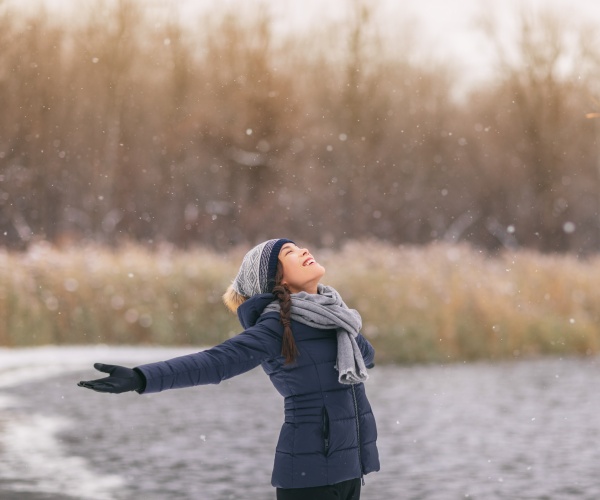 woman happy outside in cold, snow