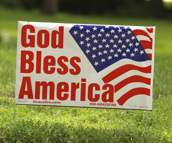 a yard sign reading god bless america