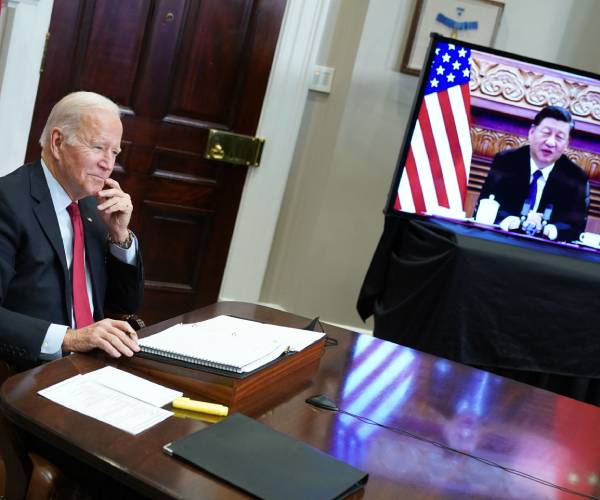 biden at his desk with xi on a television screen