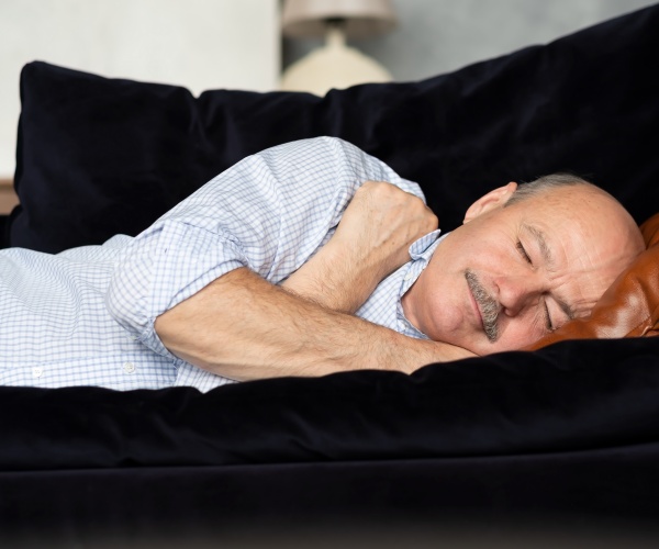 man sleeping on couch