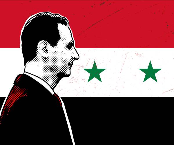 assad in front of a syrian flag