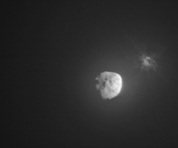 debris ejects from an asteroid