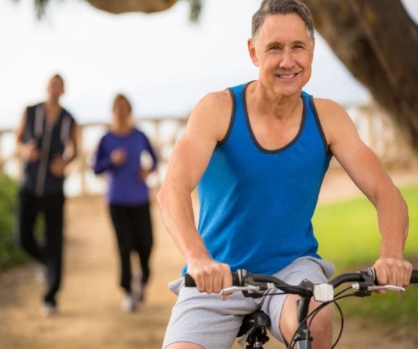 Man in park riding bicycle