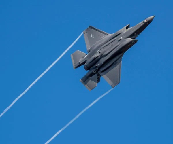 fighter jet flies through the sky