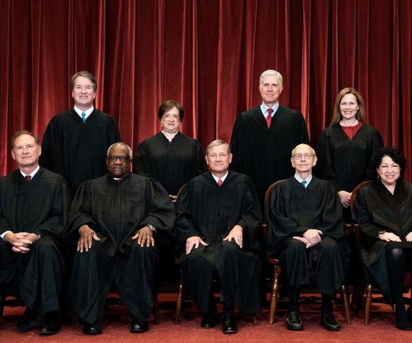 group photo of the justices in their black robes at the supreme court