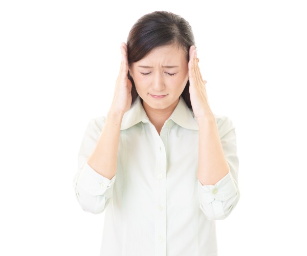 woman with hands on head, looking stressed