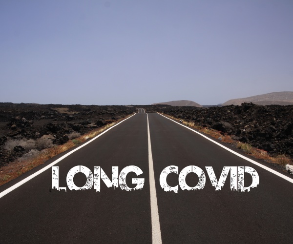 Long COVID in block letters at the beginning of long road