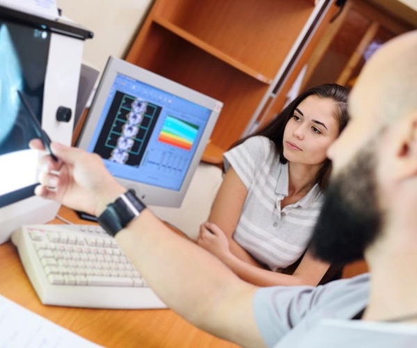 doctor going over mammogram results with young woman