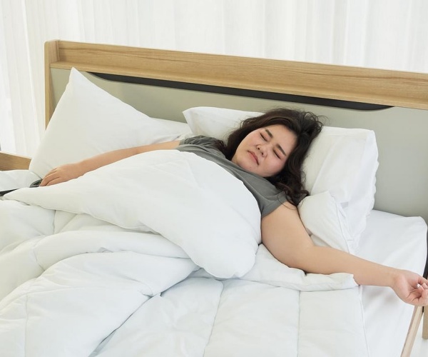 woman asleep in middle of bed