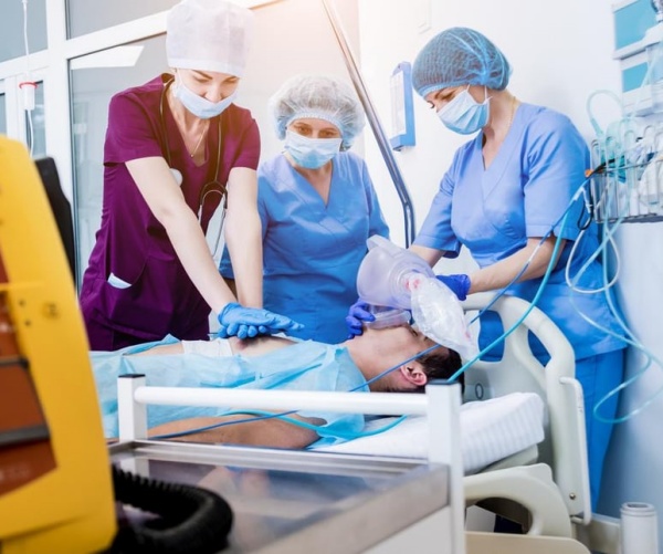 hospital workers giving CPR to patient