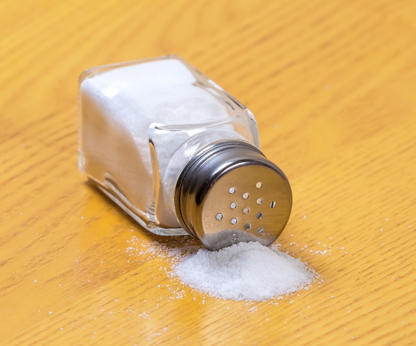 salt shaker on its side spilling out salt