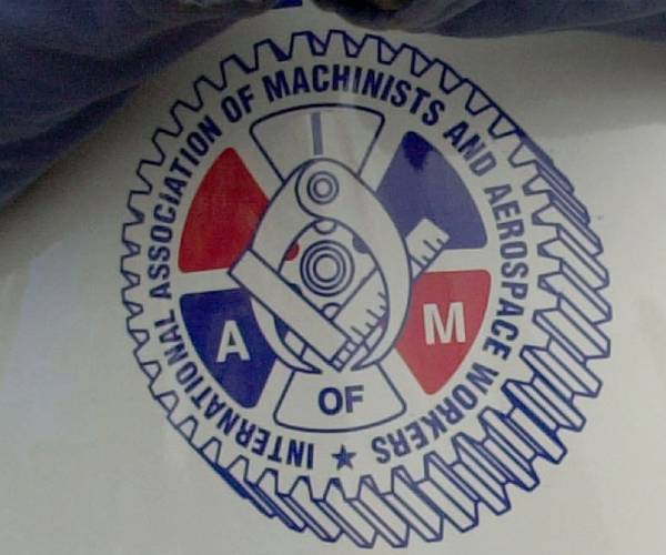 International Association of Machinists logo on a picket sign