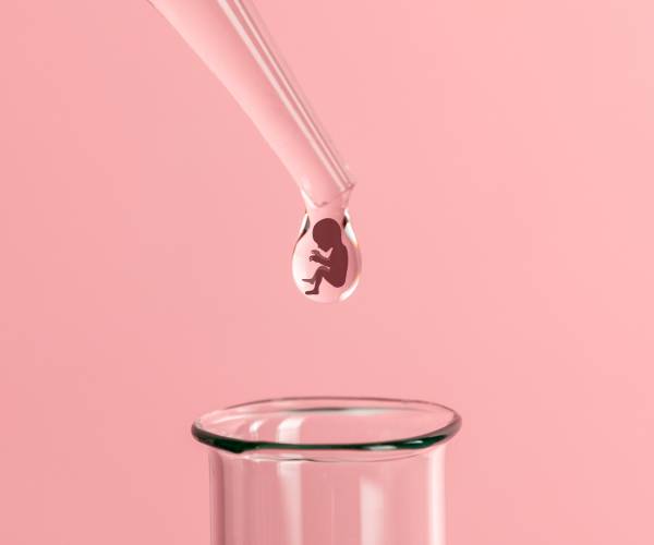 a pipette drop with silhouette of an embryo dripping into a test tube