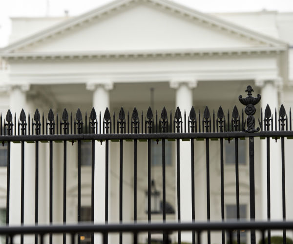 the white house with the iron fencing in front