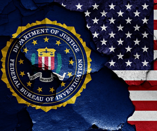 flag of FBI and USA painted on cracked wall