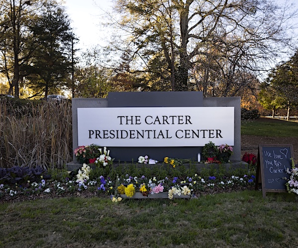 the carter presidential center sign with flowers in front