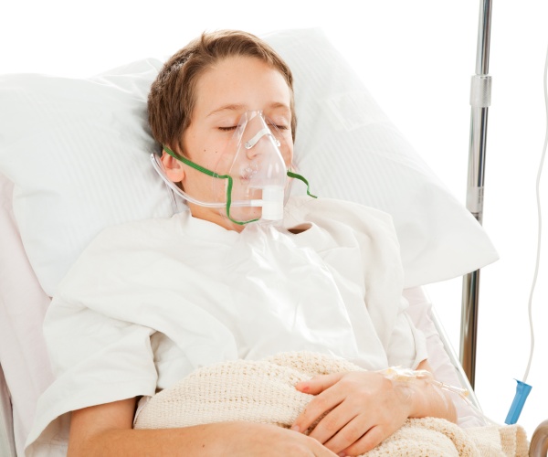 boy in hospital with oxygen mask on