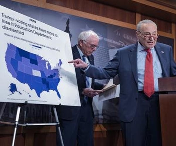 chuck schumer pointing at a map of the u.s.