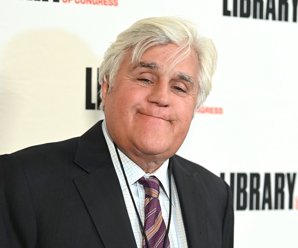 jay leno stands on red carpet