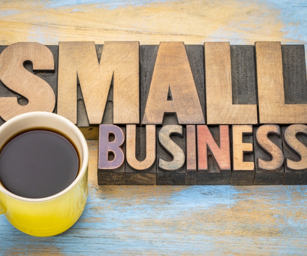 small business banner in vintage letterpress wood type blocks with a cup of coffee