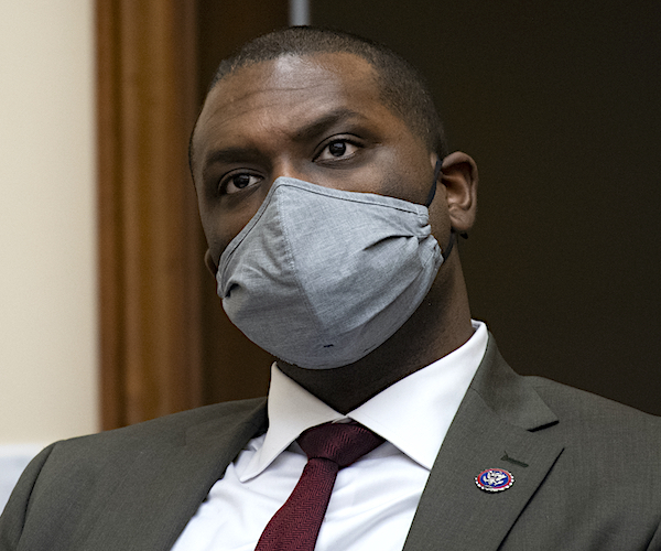 mondaire jones wears and masks and listens during a media interview