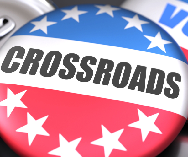 a political button with the word "crossroads" on it