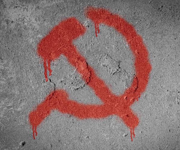 a communist hammer and sicle symbol spray painted on a wall