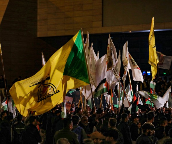 pro iran protest with various flags 