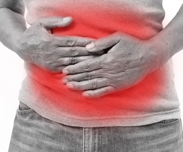 man holding stomach outlined in red indicating pain