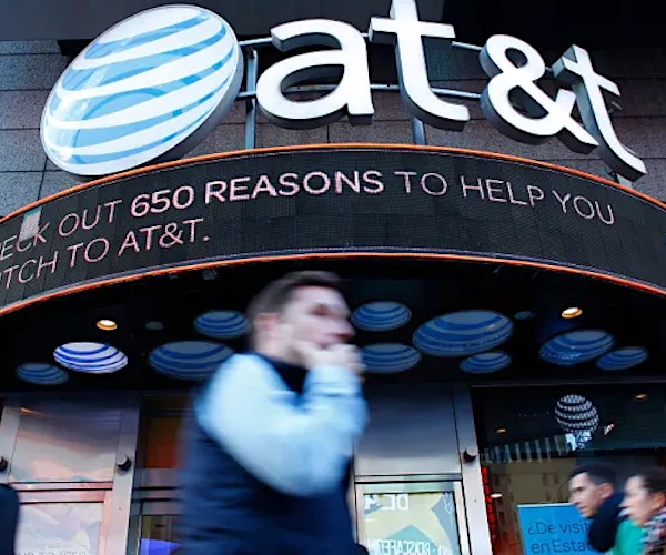 a man walks past an at&t store in manhattan