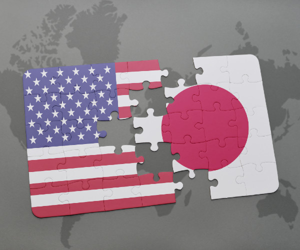 flags of the united states and japan as interlocking puzzles