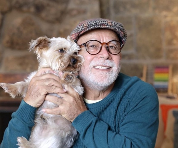older man with small dog