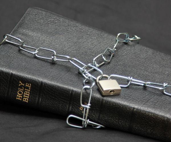 a bible with a chain and lock keeping it closed