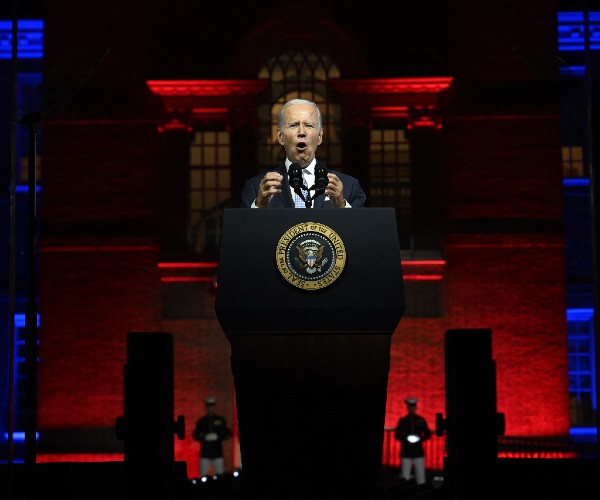 biden standing in front of independence hall flanked by marines