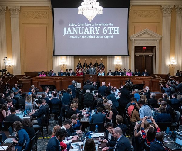 the audience, witnesses, committee members and the video screen at a meeting of the house select committee