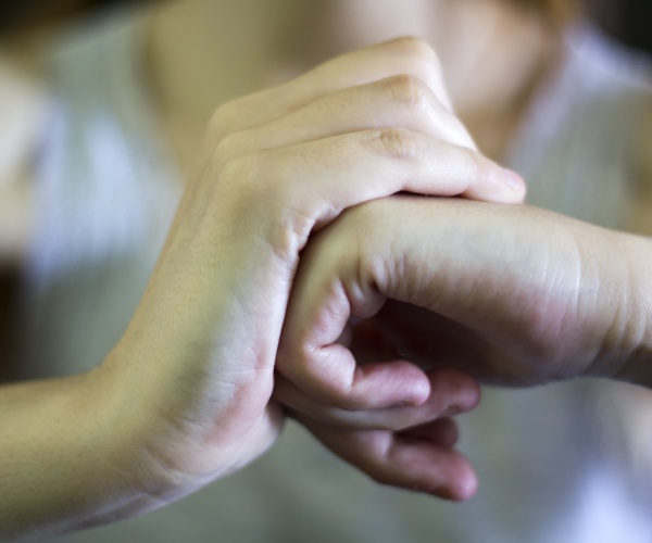 close up on hands of a person cracking their knuckles