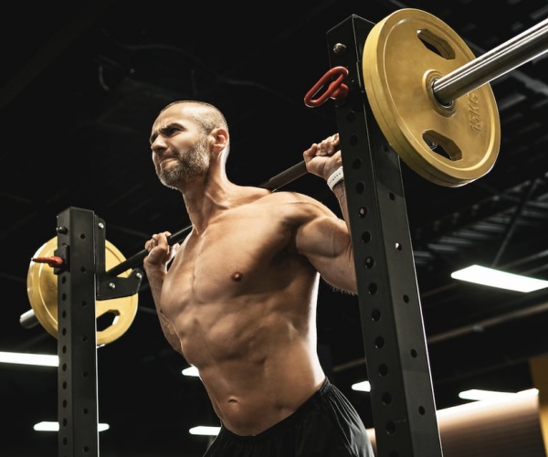 man lifting a heavy weight in gym