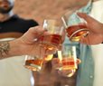 four men toast with bourbon