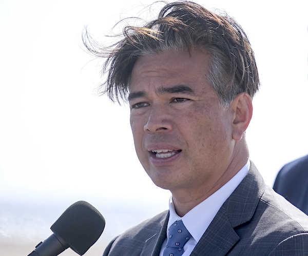 California Attorney General Rob Bonta speaks outdoors on a windy day at a news conference